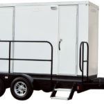 image shows a portable restroom trailer, also known as a luxury mobile tiny house trailer or portable toilet solution