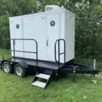 image shows a restroom trailer, which is a type of portable toilet facility